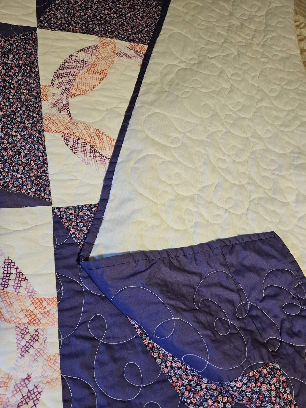 Homemade Purple Patchwork Quilt With Cross-stitch Detail